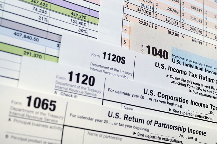 A variety of business tax forms including 1065, 1120, 1120 S, and 1040 that need to be filled out by self-employed business owners in Springfield, IL.
