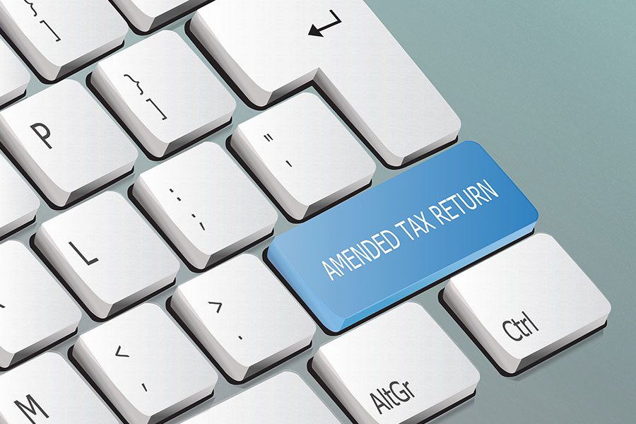 An image of a digital keyboard with the words amended tax return on a blue enter button to signify a completed and fixed tax return in Springfield, IL.