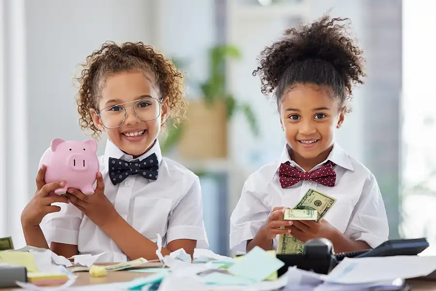 JLW TAX & BOOKKEEPING SERVICES - Children with cash and a piggy bank symbolizing the budget for a small business in Springfield, IL.