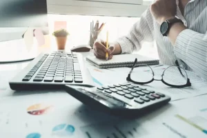 JLW Tax & Bookkeeping Services—A professional bookkeeper going through a client’s finances in Springfield, IL.