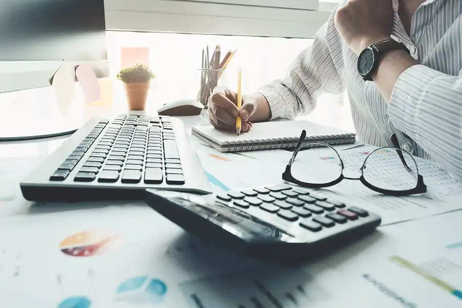 JLW Tax & Bookkeeping Services—A professional bookkeeper going through a client’s finances in Springfield, IL.