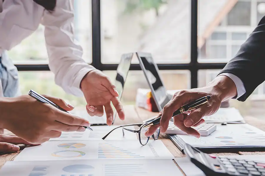 JLW Tax & Bookkeeping—Tax consultants going over bookkeeping and accounting documents in Springfield, IL.)