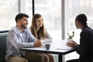 JLW Tax & Bookkeeping—A professional tax consultant meets with young business owners to discuss their bookkeeping needs in Springfield, IL.