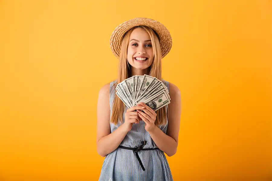 JLW Tax & Bookkeeping Services —A young woman in summer attire holding money from her side job in Springfield, IL.