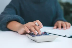 JLW Tax & Bookkeeping Services —A tax consultant at a desk with a computer and a calculator, ready to help a client with tax preparation in Springfield, IL.